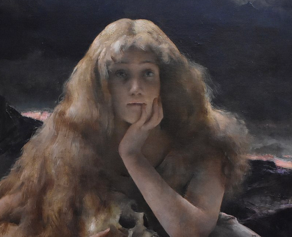 A young woman with long wavy hair that covers her shoulders holds a skull to her chest. Her left hand is on her cheek and she is staring off into the foreground as if in deep contemplation.